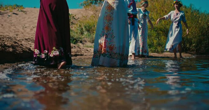 Ancient Slavs people celebrating summer solstice, closeup view of legs in river water, 4K, Prores
