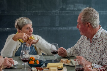 In this evocative image, a senior couple enjoys a romantic moment, sharing a toast with glasses of...
