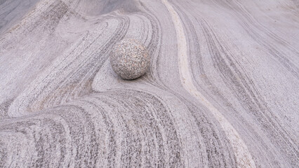 Fototapeta na wymiar spa and wellness concept with zen stone ball in a natural concept. Symbol of stability and harmony. Abstract stone background. Natural art concept.