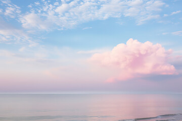 Fototapeta premium pink cloud hovering over the sea, creating a serene and ethereal scene, generative ai 