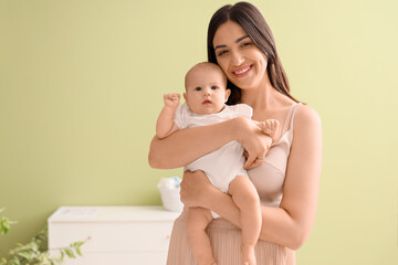 Happy mother with cute little baby in room at home