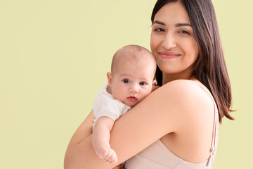 Happy mother with cute little baby in room at home