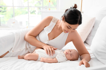Obraz premium Mother with her little cute baby sleeping in bedroom at home