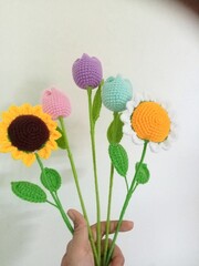 Crocheted flowers, sunflowers, tulips, colorful, handmade, white background for decoration, illustration 
