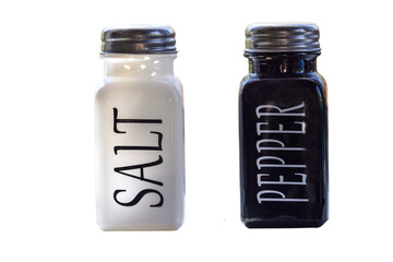 White and black ceramic bottles of salt and pepper with metal screw top lids
