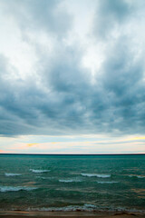 Fototapeta na wymiar Dramatic Overcast Sky Over Tranquil Lake Michigan Shoreline