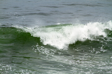 Ocean waves as water curls and forms foam in La Jolla California
