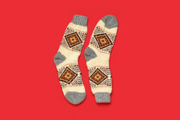 Christmas knitted socks on red background