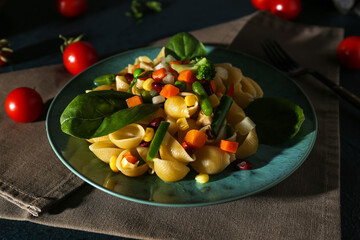 Plate with tasty pasta primavera on table