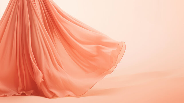 Flowing peach gown with dynamic movement on a soft peach background