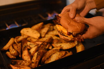 Homemade burger with rustic potatoes