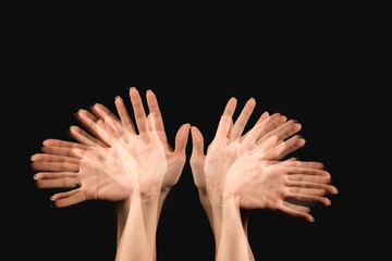 Stroboscopic photo of moving female hands on dark background
