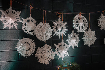 White crocheted snowflakes lie on a black background for the holiday
