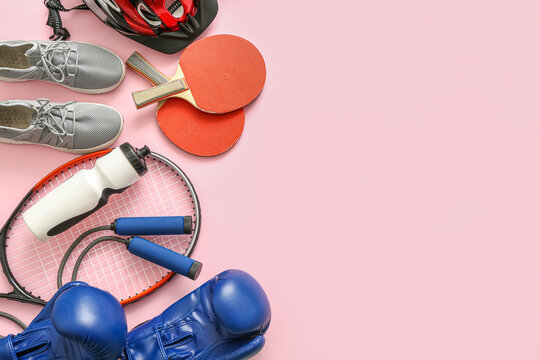 Composition with different sports equipment on pink background