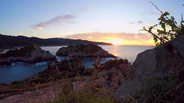 Time lapse video of sunrise on Maruata beach, Michoacan, Mexico, on a cliff, you can see how the colors of the sky and the movement of the waves change.