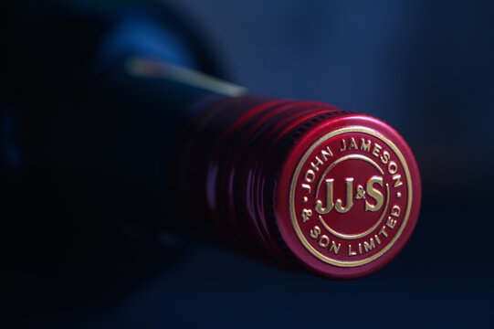 Ukraine, Chernigov 18112023 - Bottle of Jameson whiskey on a blue background, beautiful color of whiskey 1