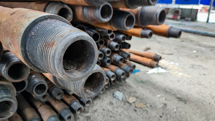 Stacked drill pipe or drill stem, used drilling rusty metal pipes