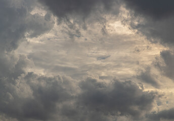 Obraz premium The sun's rays passing through the clouds and shining form an interesting light pattern against the sky. Space for text, Selective focus.