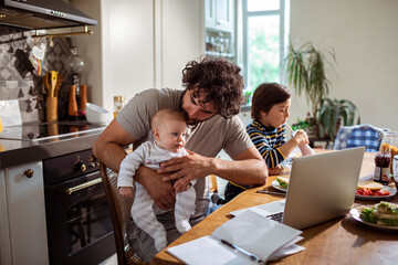 Busy Father Multitasking with Work and Children at Home