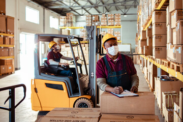 Male warehouse worker going over inventory storage