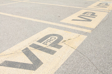 three vip pro writing caption text parking spaces spots next to each other in parking lot outside...