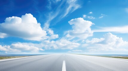 A straight open road leading towards the horizon under a bright blue sky with fluffy clouds - Powered by Adobe