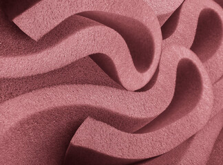rolled brown foam sponge. foam sponge rubber texture sheet. stacked spiral-style folds of material