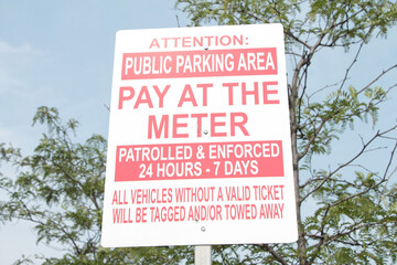 attention public parking area pay at the meter patrolled and enforced 24 hours 7 days all vehicles...