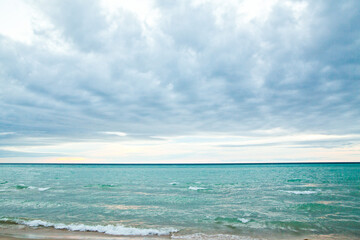 Tranquil Lake Michigan Beachscape with Gentle Waves and Cloudy Sky