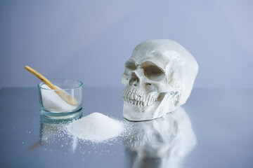 Sugar bowl with a human's skull as a concept of unhealthy lifestyle. Sugar is the most dangerous...