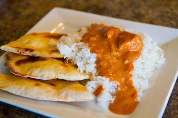 Inviting Plate of Traditional Indian Cuisine with Curry, Rice and Naan Bread
