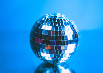 Silver disco ball with a blue background. 