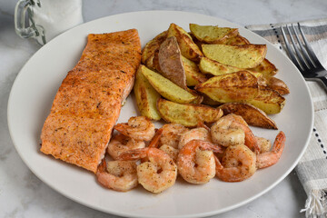 seasoned salmon  served with shrimp and potato wedges,
