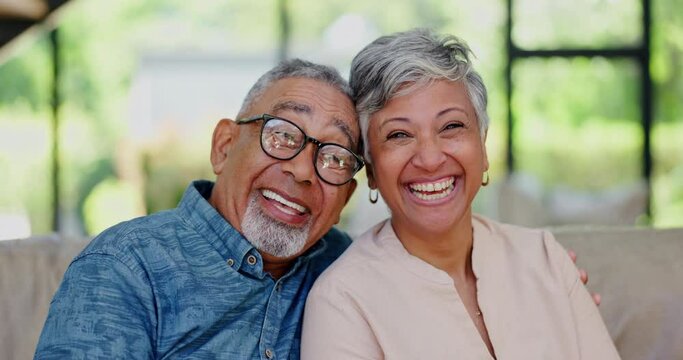 Love, face and happy senior couple on a sofa hug, laugh and relax at home together. Security, support and portrait of funny old people embrace in living room enjoying retirement, conversation or joke