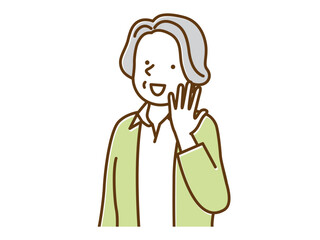 手を上げて笑いかける上品なシニア女性