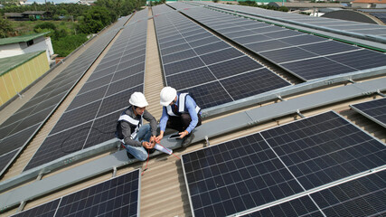 Aerial view , Business man with Solar engineer check Solar roof installation project , ecological...