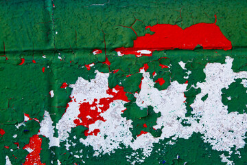 Close-up of Weathered Green, Red and White Peeling Paint Texture