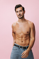 Fototapeta premium Naked man fitness torso background body belt pink lifestyle sexy jeans muscular sport muscle