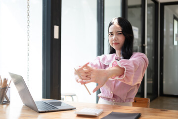 Businesswomen are serious at work causing headaches and stressed out with documents with a laptop at the office.