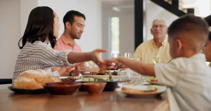 Family, holding hands and praying at dinner, table and gratitude for food, God and together in home. Grandfather, parents and kids with prayer at meal for spiritual, worship or respect from religion