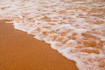 Frothy Ocean Waves Meeting Sandy Shore at Lake Michigan Close-Up