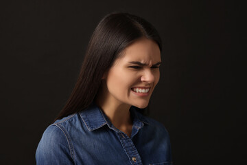 Personality concept. Emotional woman on black background