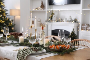 Christmas table setting with festive decor and dishware in living room