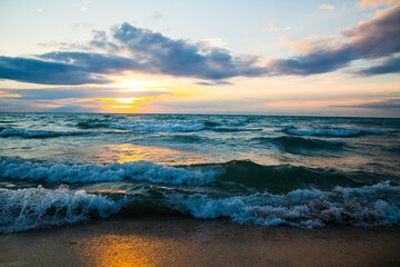 Tranquil Sunset Over Lake Michigan with Rolling Waves and Golden Glow