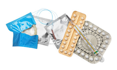 Contraceptive pills, condoms, intrauterine device and thermometer isolated on white, top view. Different birth control methods