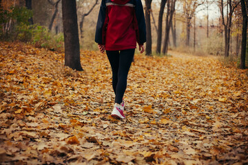Fitness Girl running at sunset  autumn orange forest