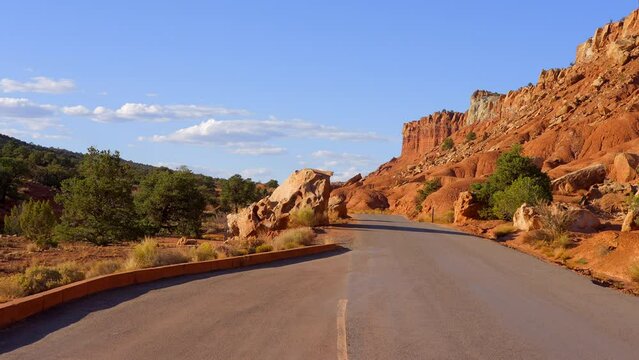Establishing shot of mountains with red rocks background in Fruita Scenic Road, Capital Reef National Park, Utah, North America. Day time on October 2023. Still camera view. ProRes 422 HQ.