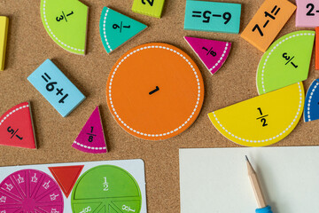 back to school background. colorful math fractions and notebook on the table. Mathematics and...