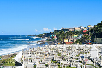 Fototapeta na wymiar Tombstones at the historic, oceanfront, colonial-era Santa Maria Magdalena de Pazzis Cemetery or Old San Juan Cemetery on the island of Puerto Rico, United States.