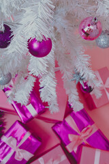 Close-up of white Christmas tree with ball, pink, purple and silver.